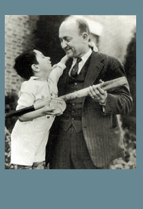 Photo of man and child holding baseball bat
